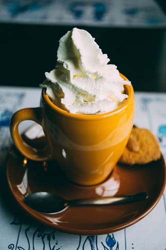 whipped cream coffee latte on ceramic mug drink